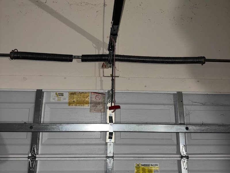 Garage door torsion spring and shaft seen from inside the garage